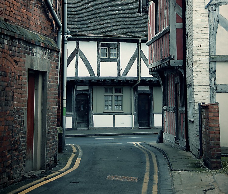A tudor beamed building at the end of a narrow street