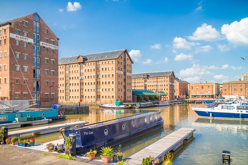A view of Gloucester docks with boats and old warehouses