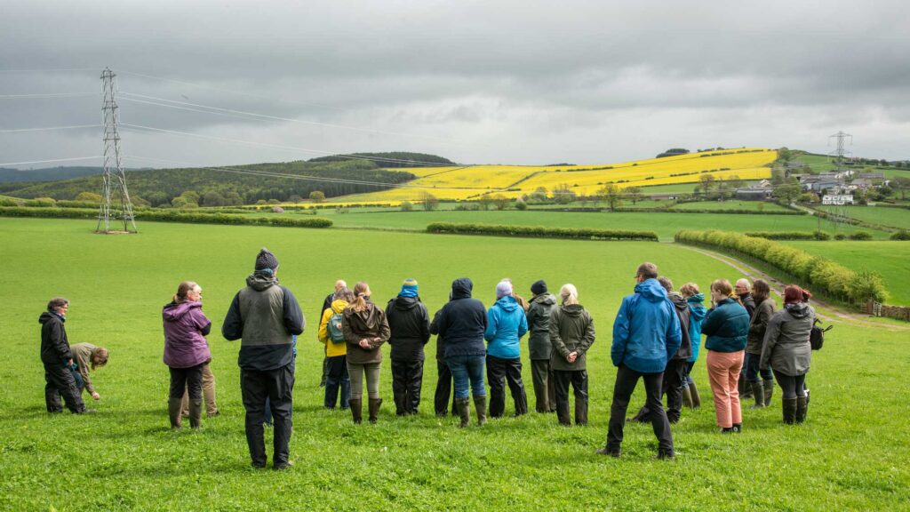 Image of a group of researchers from a Climathon looking out over a landscape of fields.